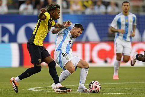 Messi battles with Ecuador's Joao Ortiz